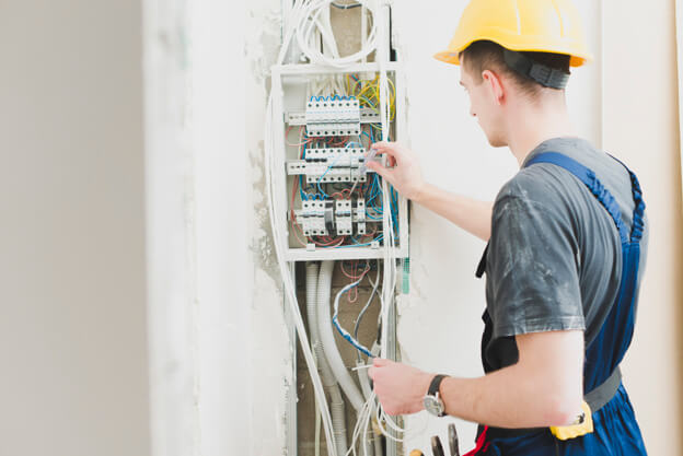 electrician-working-with-switchboard_23-2147743117-1-2